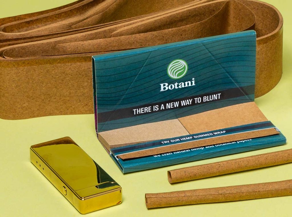 Botani Gummed Wrap for Blunts next to Hemp paper, gold lighter and rolled blunts